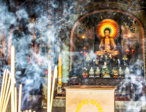 incense sticks and buddhas are all around